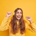 horizontal-shot-upbeat-dark-haired-woman-uses-headphones-moves-body-enjoys-new-playlist-cheerful-expression-likes-tune-wears-yellow-jacket-smiles-broadly-has-fun_273609-54580-1024×682