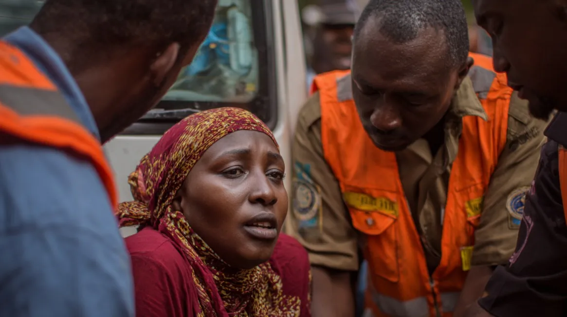 How Reliable Power Transforms Rural Health and Education in Africa 20 Woman in distress receiving help from emergency responders in orange vests